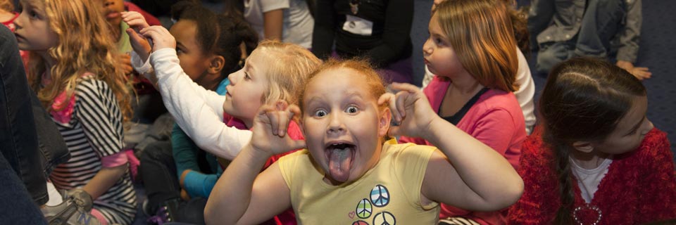 One of these kids is having an exceptionally good time.